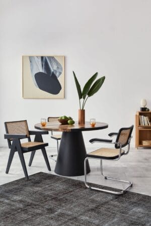 Een moderne eetkamer met een zwarte tafel en stoelen.