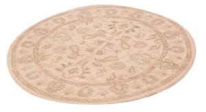 Een rond vloerkleed met een beige design.