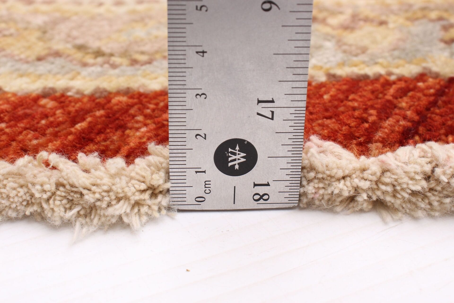 Voor het meten van de maat van een vloerkleed wordt een liniaal gebruikt.