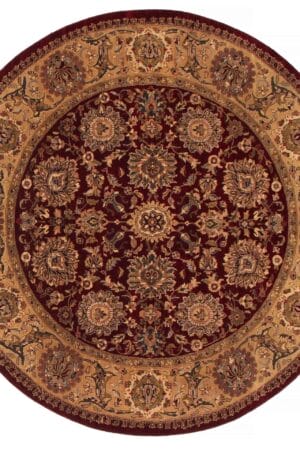 Een rond tapijt/vloerkleed met een sierlijk ontwerp in bordeauxrood en bruin.