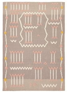 De Indiase Marrakech plat geweven wollen kelim, met een formaat van 157 x 226 cm, heeft een geometrisch patroon in pastelroze, wit en geel op een grijze achtergrond met ingewikkelde zigzaglijnen, visgraatpatronen en verticale lijnen.